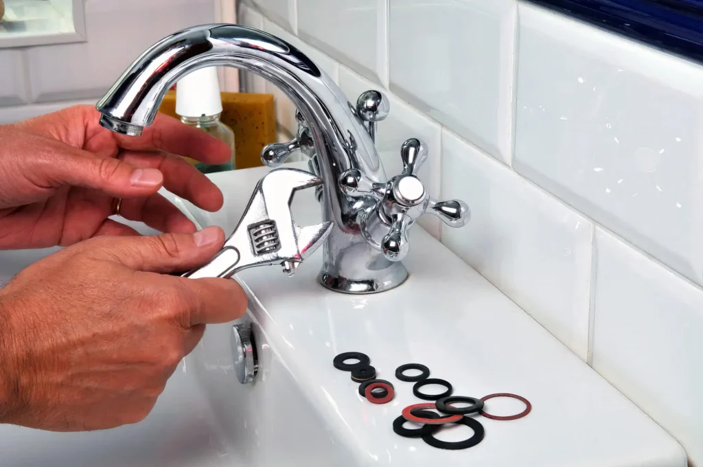 Plumber performing maintenance on a bathroom faucet in Harrisburg
