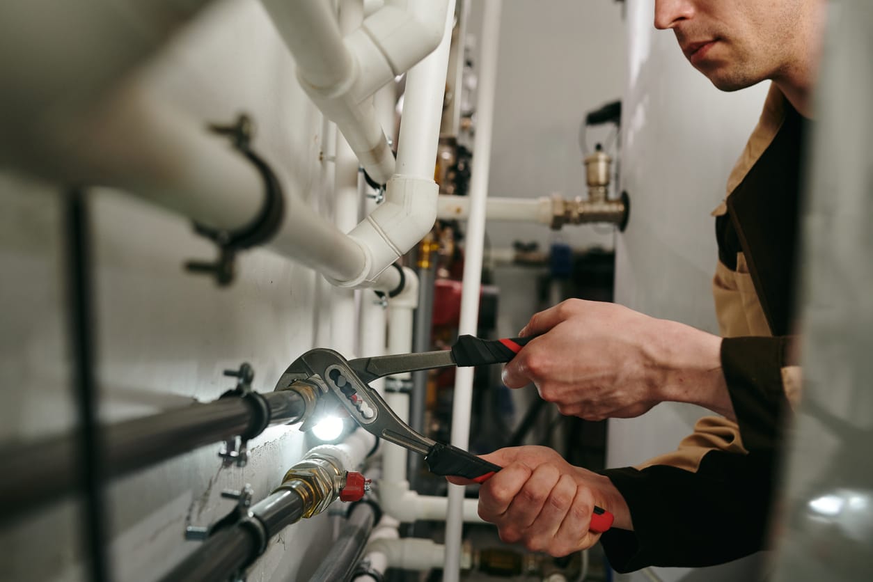 Plumbers maintaining commercial plumbing pipes in Harrisburg