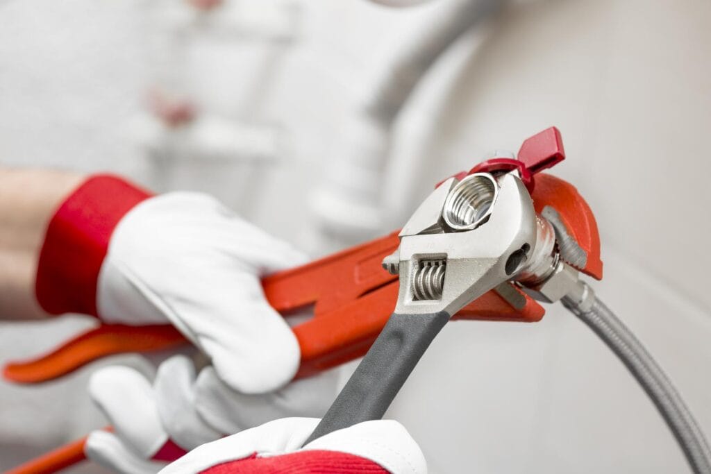 Plumber holding pipe wrenches for an emergency repair in Harrisburg