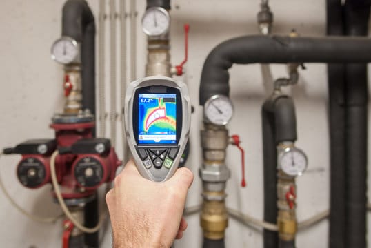 Plumber using a thermal imaging camera to inspect pipes in Harrisburg