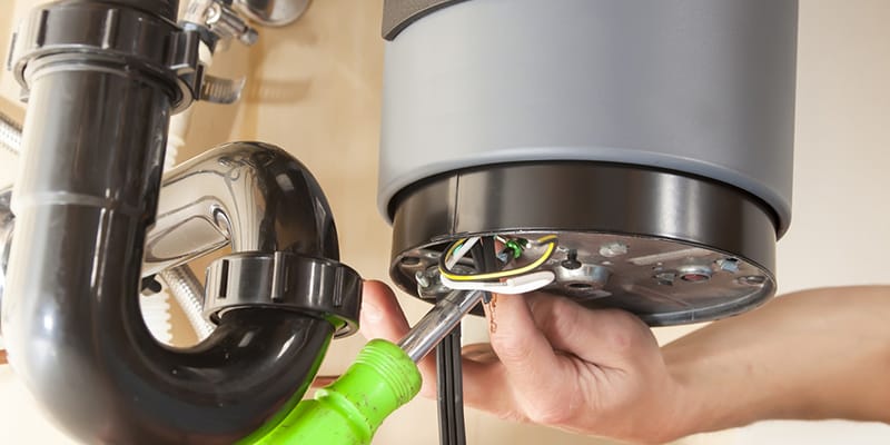Technician repairing the heating element of a water heater in Harrisburg