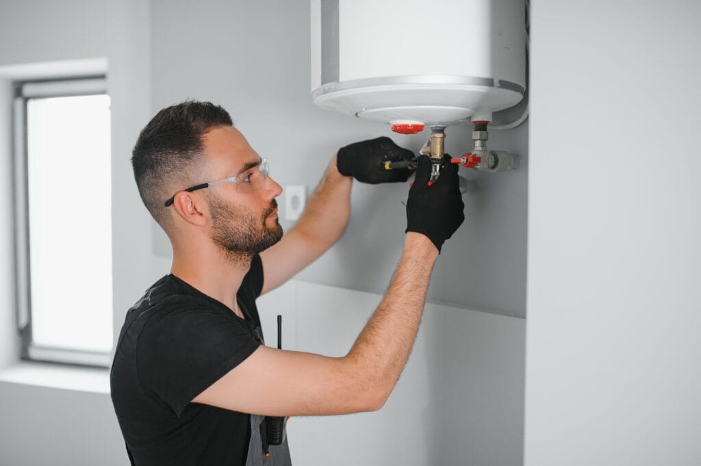 Technician performing water heater maintenance in Harrisburg