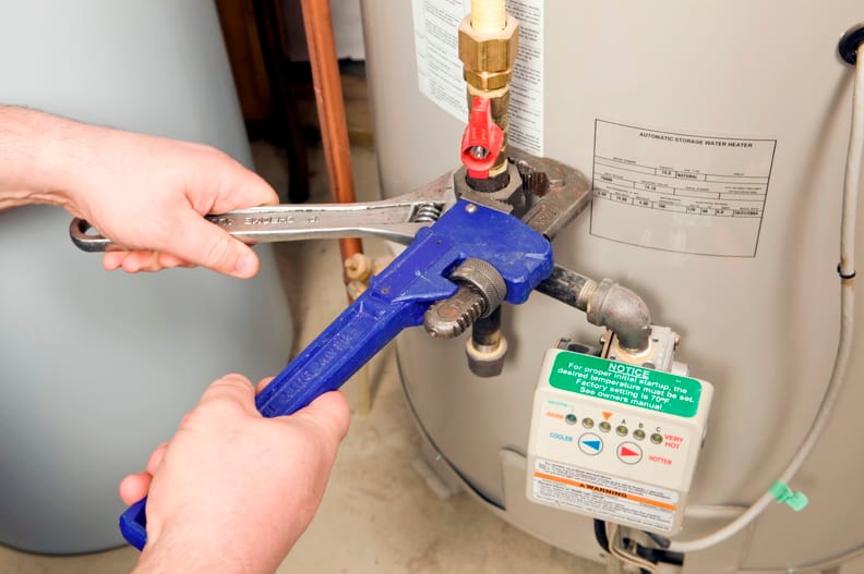 Plumber repairing a water heater valve in Harrisburg
